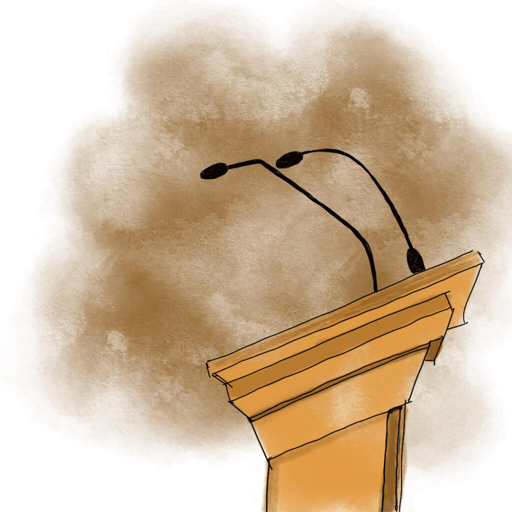 A side-view of a podium with mics on it, in front of a dusty brown haze.