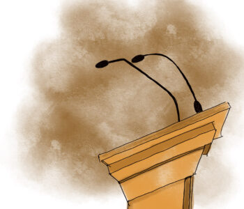 A side-view of a podium with mics on it, in front of a dusty brown haze.